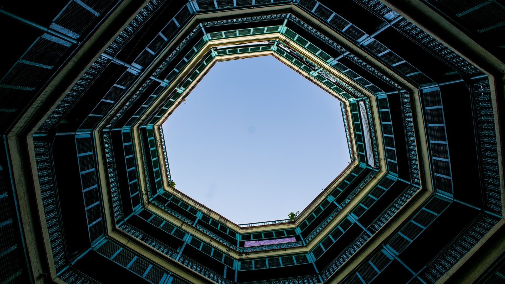 Looking up at the sky from within a hexagonal building