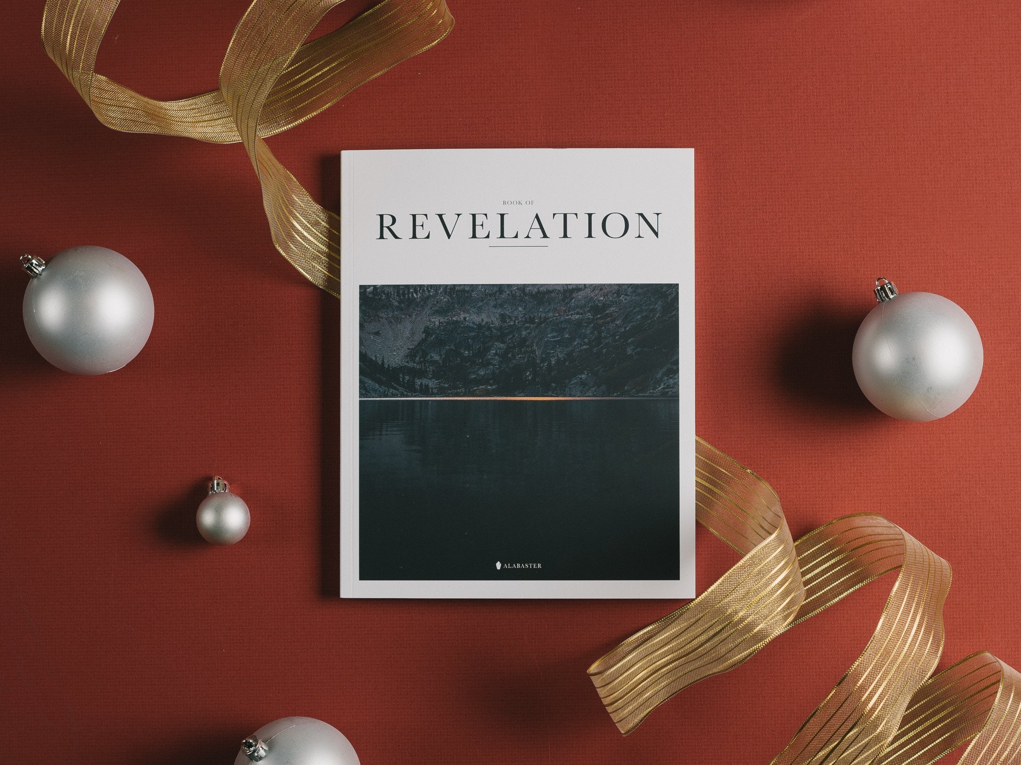 The Book of Revelation with ornaments and ribbon