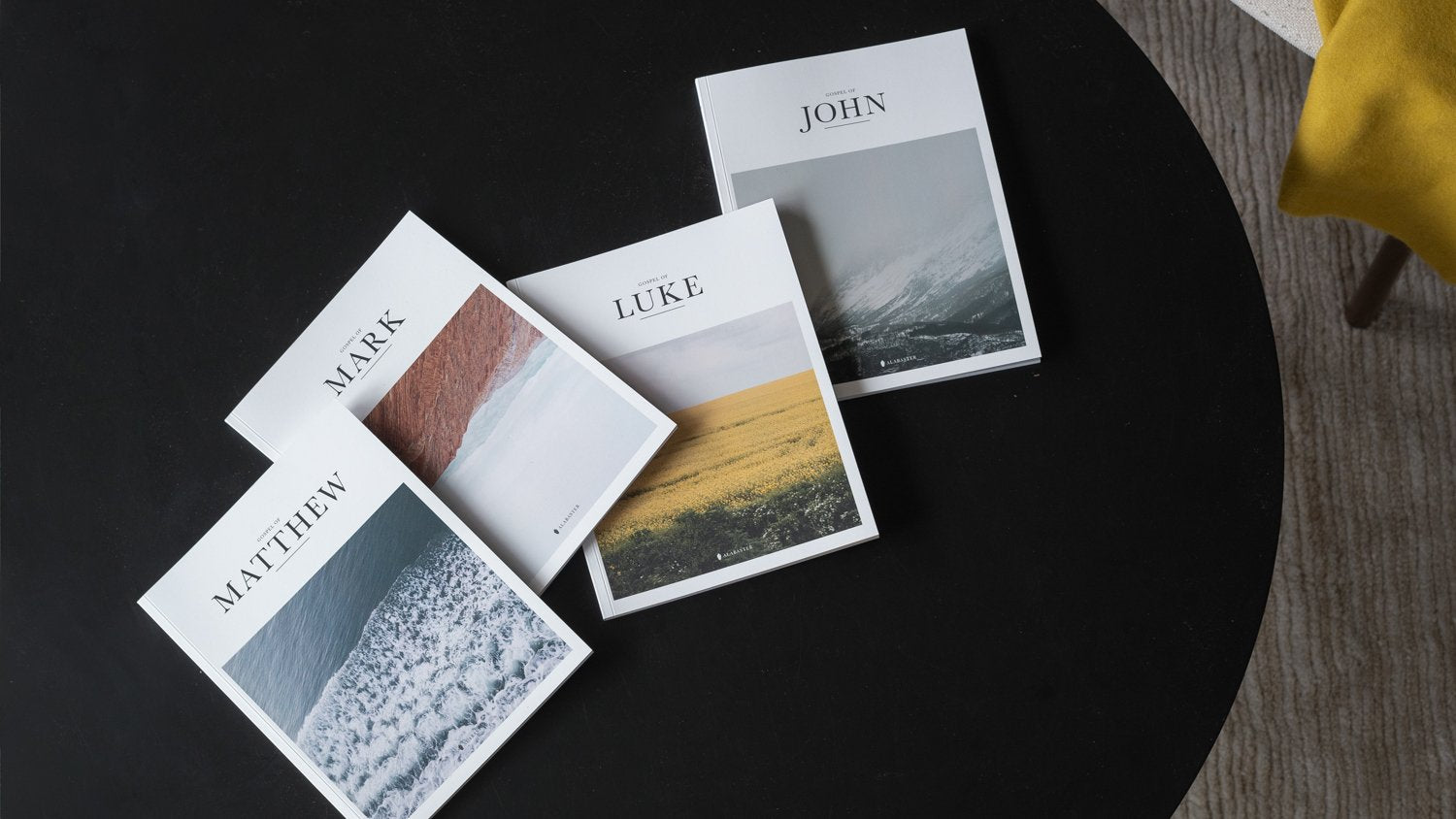 The Four Gospels on black coffee table